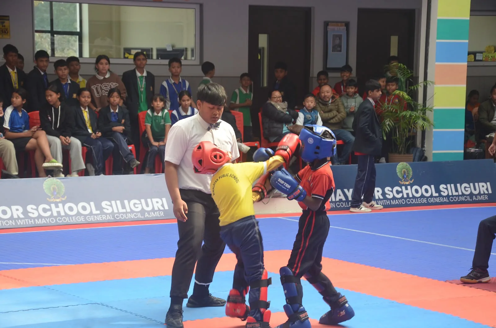 Students sparring in a kickboxing match on campus